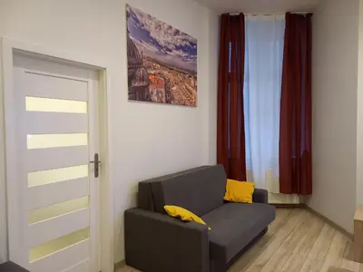 a living room with a couch and a window at Old Town Apartments - B7 in Kraków