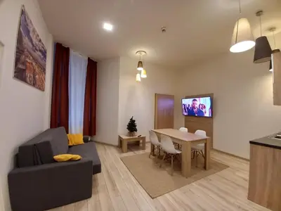a living room with a couch and a dining room table at Old Town Apartments - B7 in Kraków
