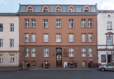 a large brick building with a clock on it at Old Town Apartments - B7 in Kraków
