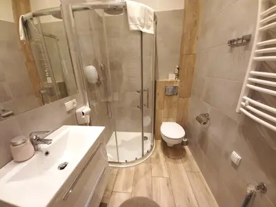 a bathroom with a shower and a toilet and a sink at Old Town Apartments - B7 in Kraków