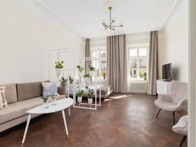 a living room with a couch and a table with plants at 3 bedroom apartment - Rejtana 10 in Kraków