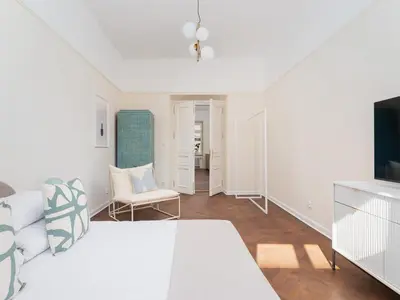 a white room with a bed and a tv at 3 bedroom apartment - Rejtana 10 in Kraków
