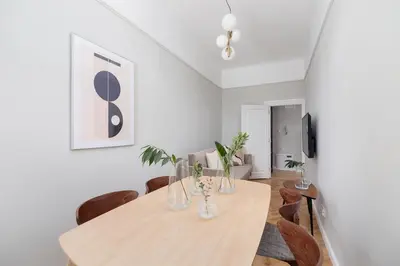 a dining room with a wooden table and chairs at 3 bedroom Apartment with the balcony - Rejtana 10 in Kraków