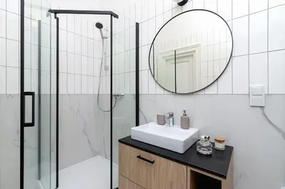 a bathroom with a sink and a mirror at 3 bedroom Apartment with the balcony - Rejtana 10 in Kraków