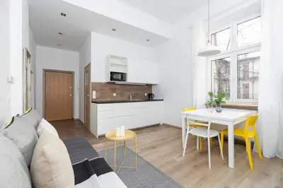 a living room with a couch and a table at 1 Bedroom Apartment - Ludwika Zamenhofa 6 street in Kraków