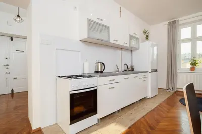 a kitchen with white cabinets and a stove top oven at 2 bedroom apartment - Old Town - Zwierzyniecka 8 street in Kraków