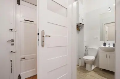 a white bathroom with a toilet and a sink at 2 bedroom apartment - Old Town - Zwierzyniecka 8 street in Kraków