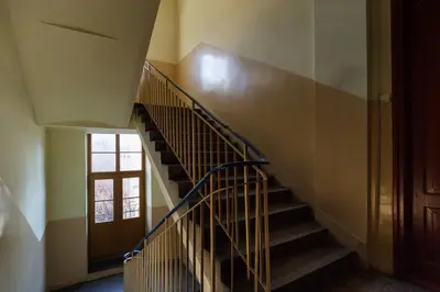 a spiral staircase in a building with a window at 2 bedroom apartment - Old Town - Zwierzyniecka 8 street in Kraków