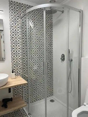 a shower with a glass door in a bathroom at Wawel Crown Apartments in Kraków