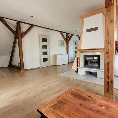 a large living room with a fireplace and wooden beams at Dom dla 6 osób in Oświęcim