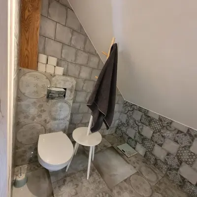 a small bathroom with a toilet and a chair at Dom dla 6 osób in Oświęcim