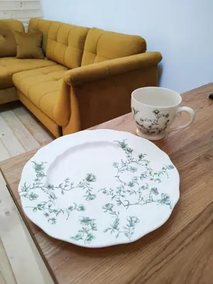 a plate and a coffee cup on a table at Domek Pocieszna Podkowa in Rabka-Zdroj