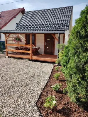 a house with a porch and a deck at Domek Pocieszna Podkowa in Rabka-Zdroj
