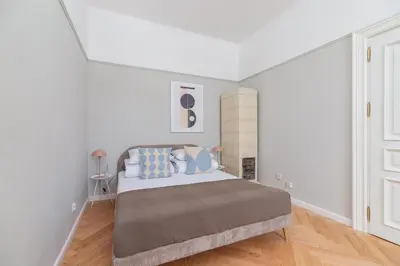 a bedroom with a large bed with blue pillows at 2 - bedroom Apartment with balcony - Rejtana 10 in Kraków