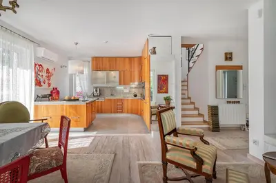 a kitchen and living room with a table and chairs at Villa Marta in Trzebinia