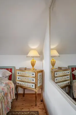 a bedroom with a dresser and a mirror at Villa Marta in Trzebinia
