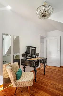 a piano in a room with a chair and a mirror at Villa Marta in Trzebinia