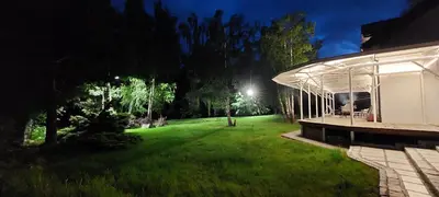 a backyard at night with a building and a lawn at Villa Marta in Trzebinia
