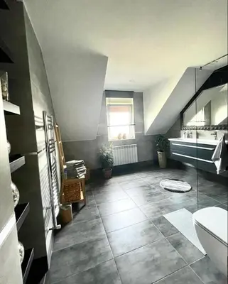 a large bathroom with a large tile floor with a window at Domek u Gosi in Zator