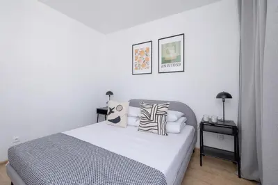 a bedroom with a bed with pillows on it at 4 bedroom apartment with a balcony - Prochowa 1 in Kraków