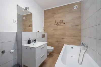 a bathroom with a white sink and a toilet at 4 bedroom apartment with a balcony - Prochowa 1 in Kraków