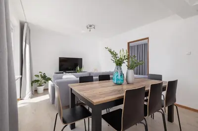 a dining room with a table and a couch at 4 bedroom apartment with a balcony - Prochowa 1 in Kraków