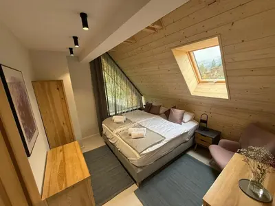 a small room with a bed and a window at Szlak By Trafił in Poręba Wielka