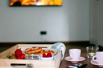 a tray with pastries and strawberries on a table at Dom z ogrodem i prywatnym parkingiem w Krakowie in Kraków