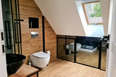 a bathroom with a toilet and a sink at Dom z ogrodem i prywatnym parkingiem w Krakowie in Kraków