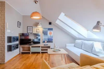 a living room with a couch and a tv at Kraków Castle View - Spacious Apartment - by Rentujemy in Kraków