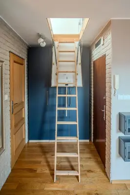 a ladder in a room with a blue wall at Kraków Castle View - Spacious Apartment - by Rentujemy in Kraków