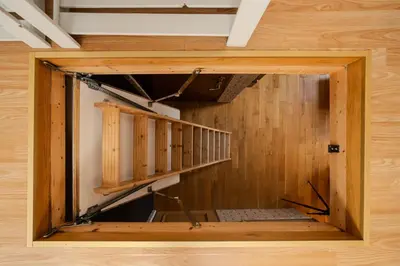 a room with a staircase in a wooden wall at Kraków Castle View - Spacious Apartment - by Rentujemy in Kraków
