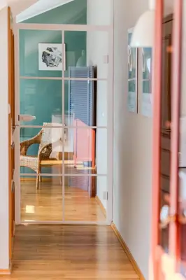 a hallway with a glass door leading into a room at Kraków Castle View - Spacious Apartment - by Rentujemy in Kraków