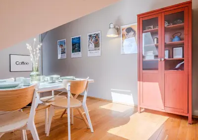 a dining room with a table and chairs and a cabinet at Kraków Castle View - Spacious Apartment - by Rentujemy in Kraków