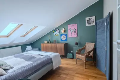 a bedroom with a bed and a chair at Kraków Castle View - Spacious Apartment - by Rentujemy in Kraków