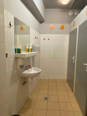 a bathroom with a sink and a mirror at Art Inn Space in Kraków