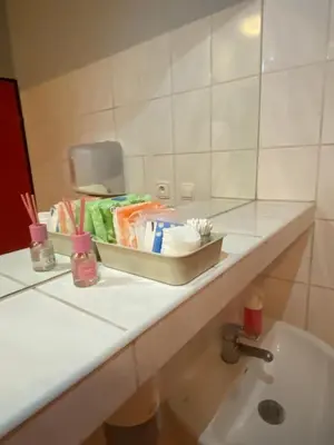 a bathroom counter with a sink and a mirror at Art Inn Space in Kraków