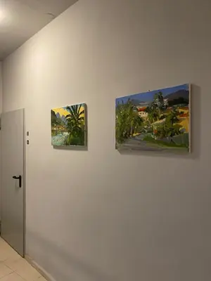 three paintings are hanging on a wall at Art Inn Space in Kraków