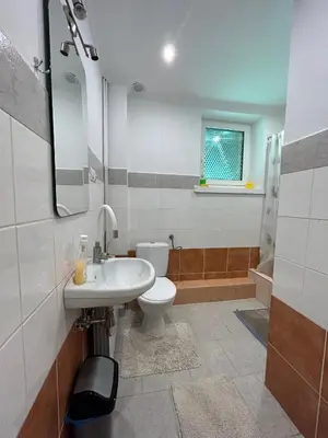 a bathroom with a white sink and a toilet at Leśniewscy - Pokoje Gościnne in Ojców