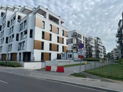 a large white building on the side of a street at Sunrise Apartment in Kraków