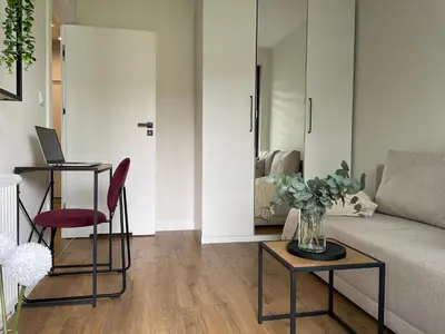 a living room with a couch and a table at Apartament na Krowodrzy in Kraków