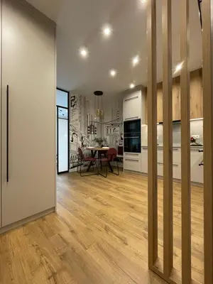 a kitchen and dining room with a table in a room at Apartament na Krowodrzy in Kraków