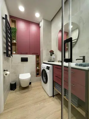 a bathroom with purple cabinets and a washing machine at Apartament na Krowodrzy in Kraków
