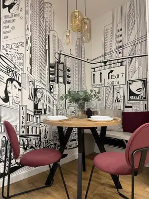 a dining room with a table and two red chairs at Apartament na Krowodrzy in Kraków