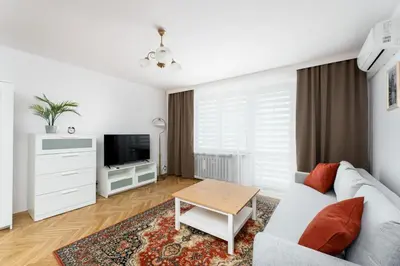 a living room with a couch and a table at Old Town Standard Studio by BookingHost in Kraków