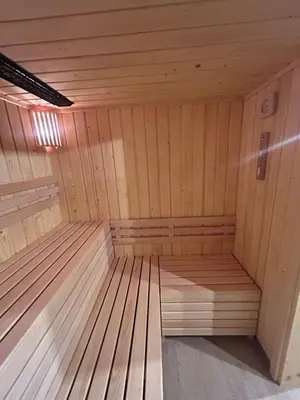 a wooden sauna with a bench in the middle at U Boku Stoku - Domki w Kasinie in Kasina Wielka