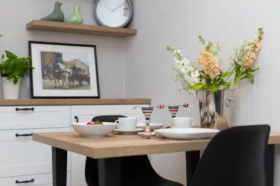 a dining room table with bowls and flowers on it at Cozy 1-bedroom apartment, Heart of Cracow in Kraków