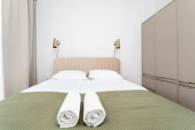 a bedroom with a bed with white towels on it at Lema Apartment near Tauron Arena in Kraków