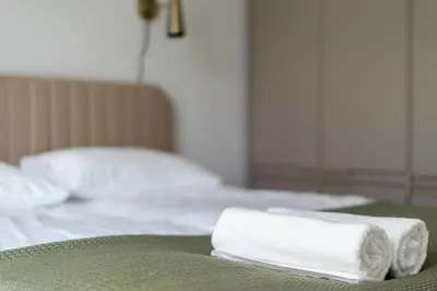 two towels sitting on top of a bed at Lema Apartment near Tauron Arena in Kraków