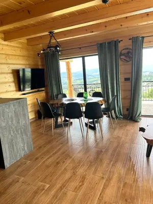 a dining room with a table and chairs at Dom Na Brzegu in Limanowa